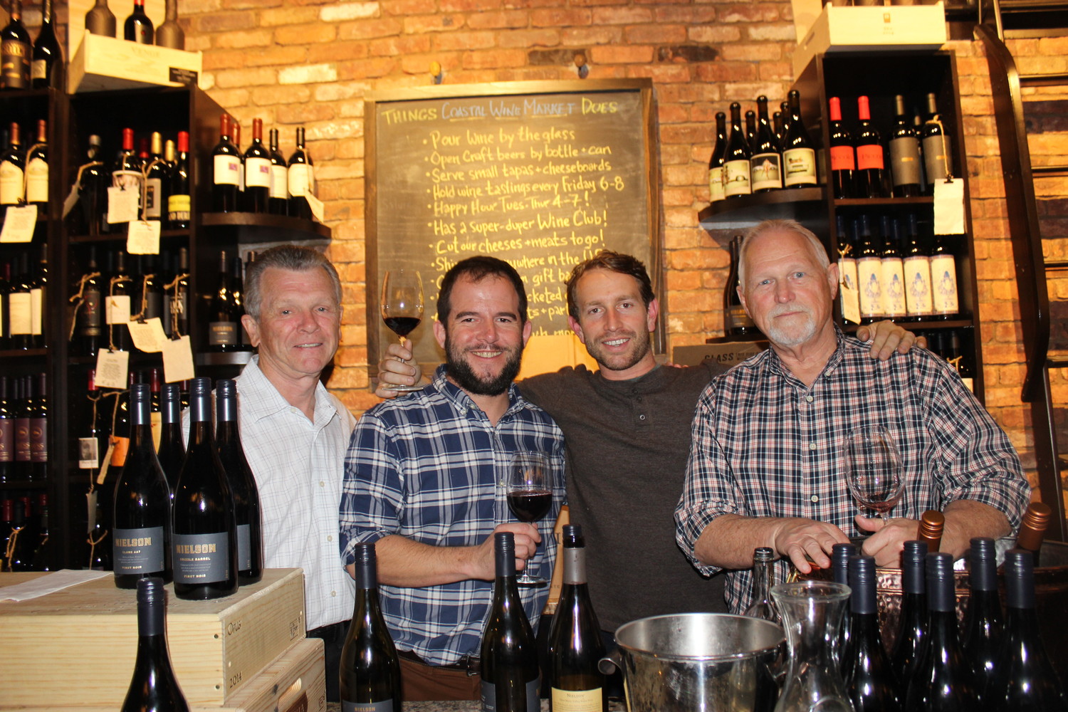 Dennis Mahoney, Steve Lourie, Ryan Pace and Allen Horne gather at the “Meet The Winemaker event” at Coastal Wine Market & Tasting Room on March 22.